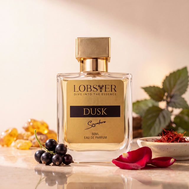 Dusk eau de parfum on a cream studio set with blackcurrants, rose petals and saffron