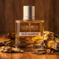 Perfume bottle labeled 'Oud Marine' by Lobster on a wooden surface with natural elements.