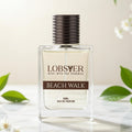 Perfume bottle labeled 'Lobster Beach Walk' with green leaves and flowers in the background
