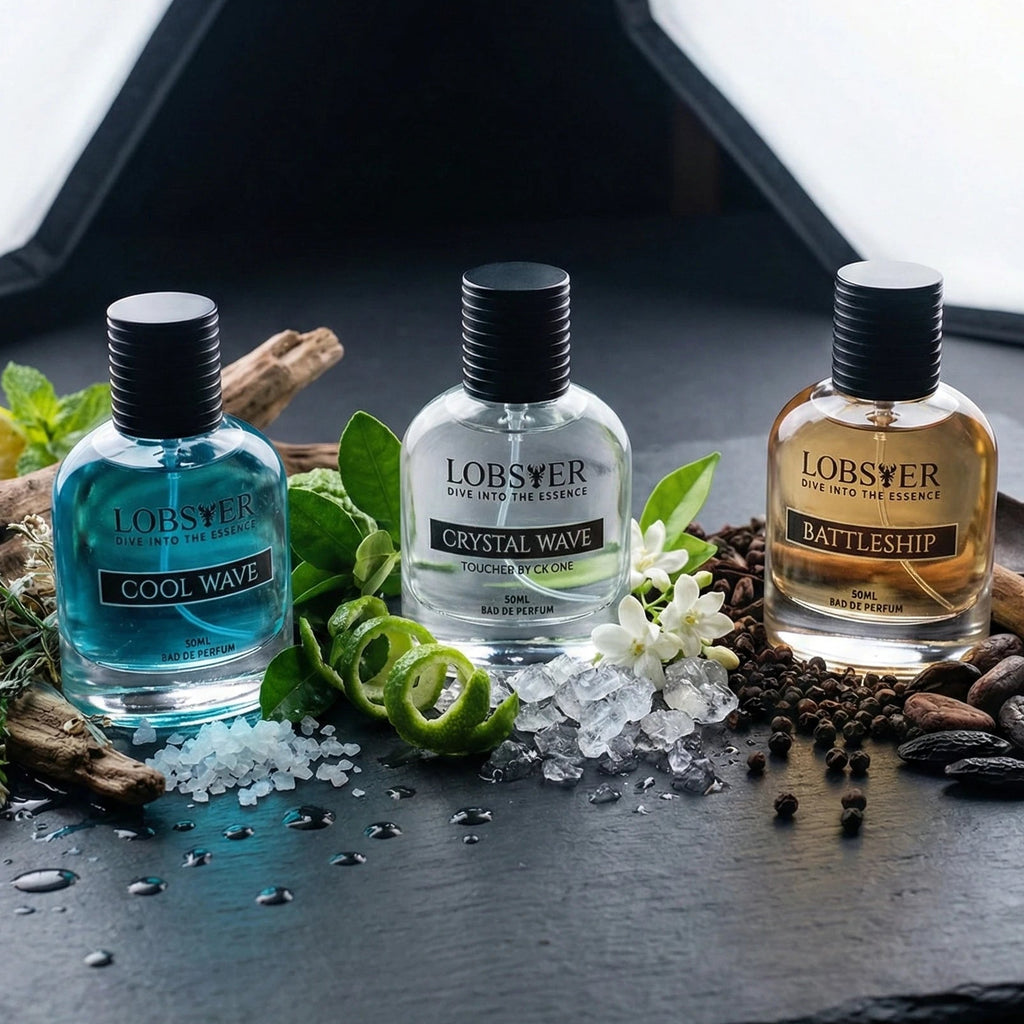 Three bottles of Lobster brand products on a dark surface with decorative elements.