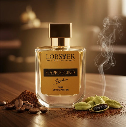 LOBSTER Cappuccino perfume bottle with coffee beans and cardamom on a wooden surface.